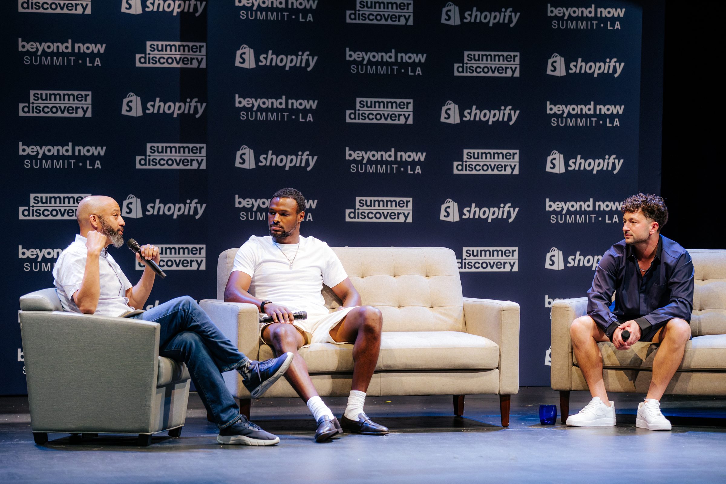 Three speakers in conversation on stage at the 2026 Beyond Now Summit at UCLA